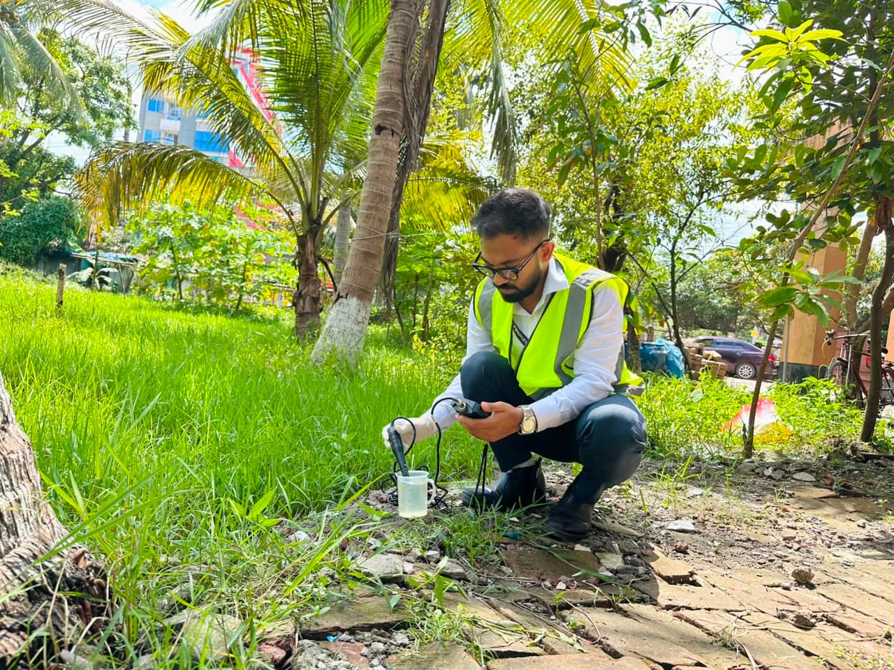 SRCL specialists conducting a field assessment near a river in Bangladesh as part of project planning.